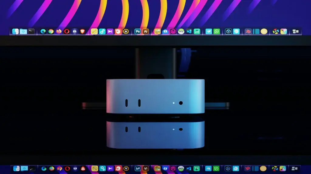MiniPC prateado refletido em mesa preta com tela mostrando dock de aplicativos e iluminação vibrante.